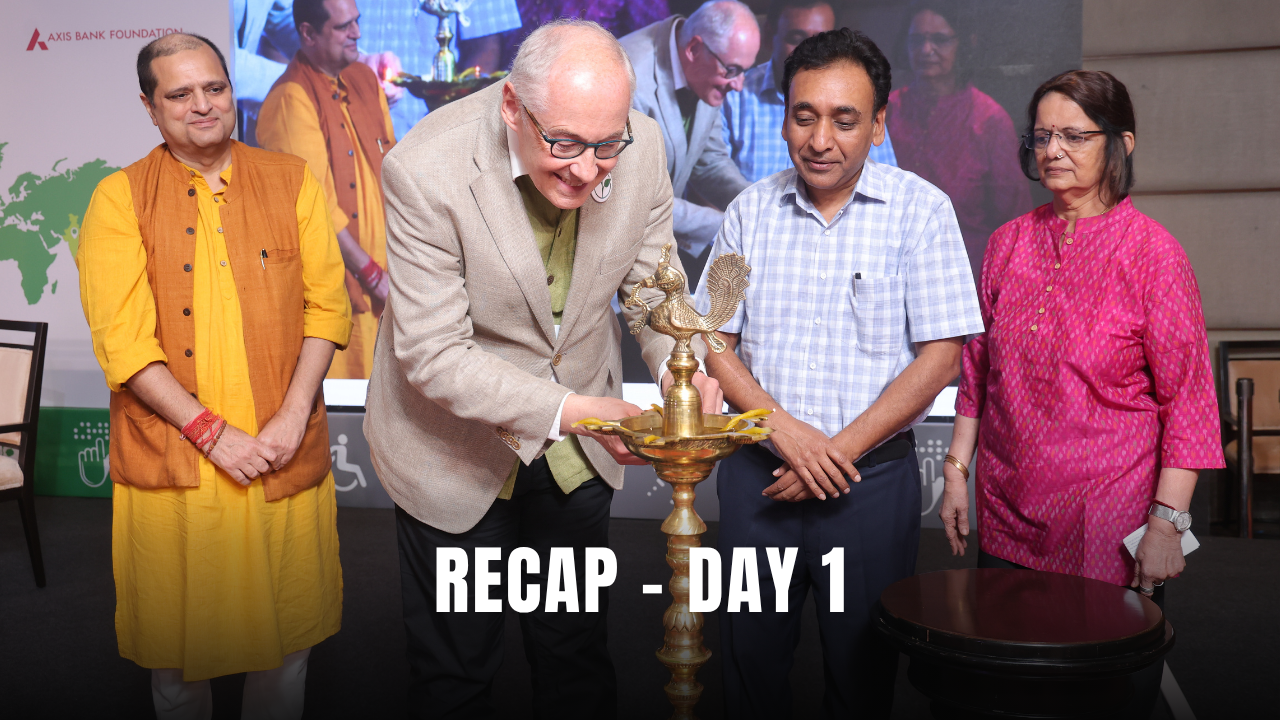 Group in colorful attire lights the ceremonial lamp on stage at Zero Project India Conference 2024 – Day 1 Recap.